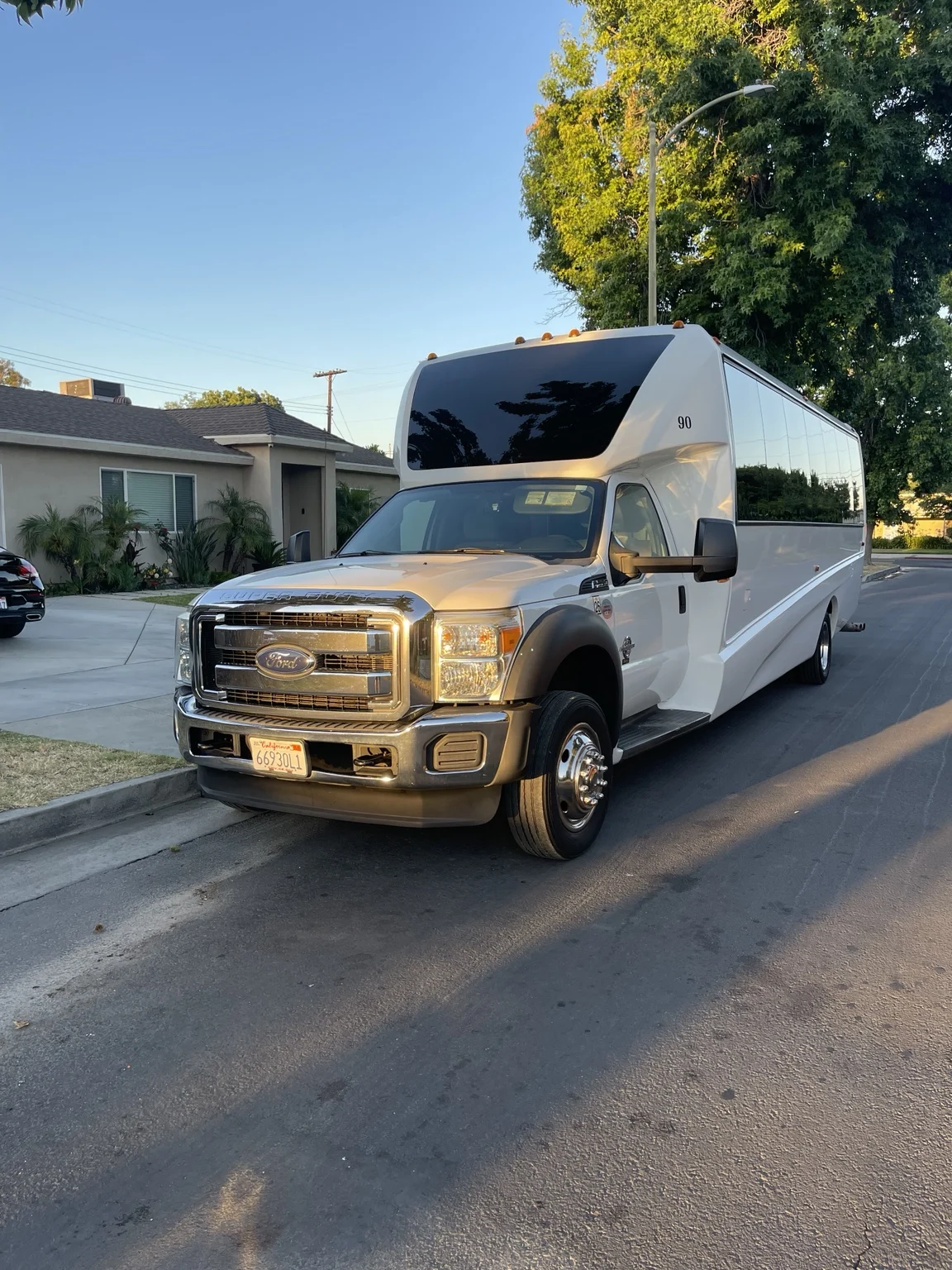 White Ford party bus viewed from the front during daylight