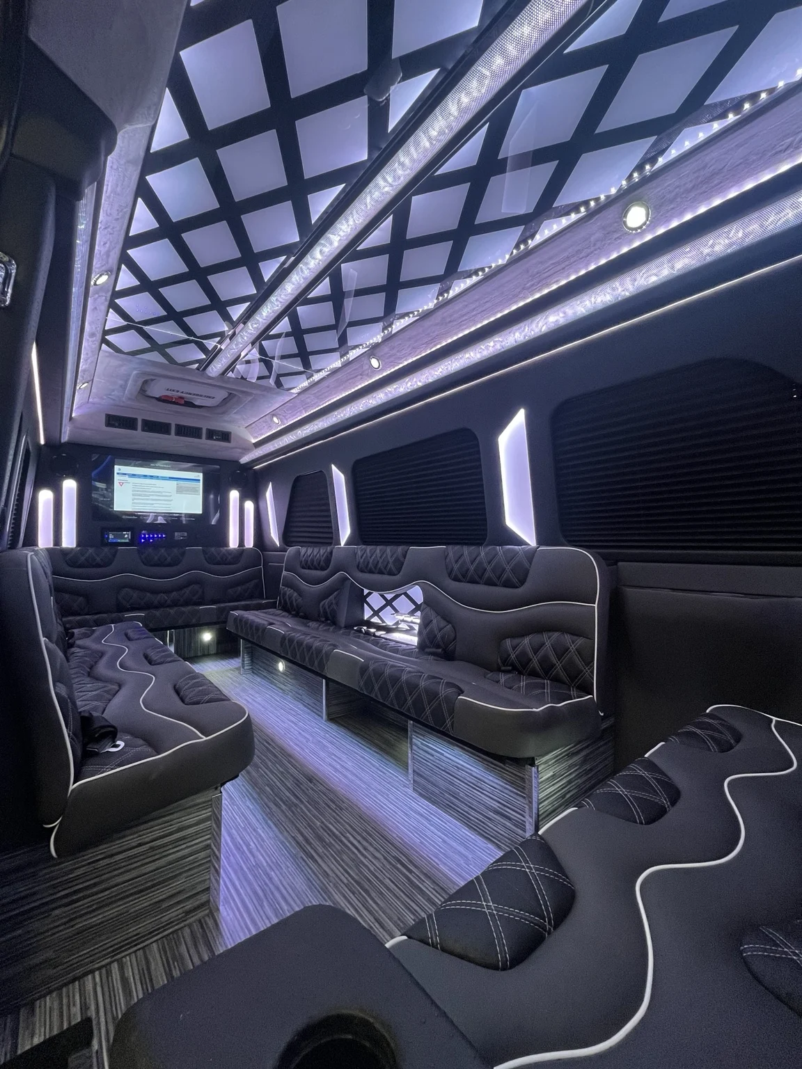 Lounge seating and illuminated geometric ceiling inside the vehicle