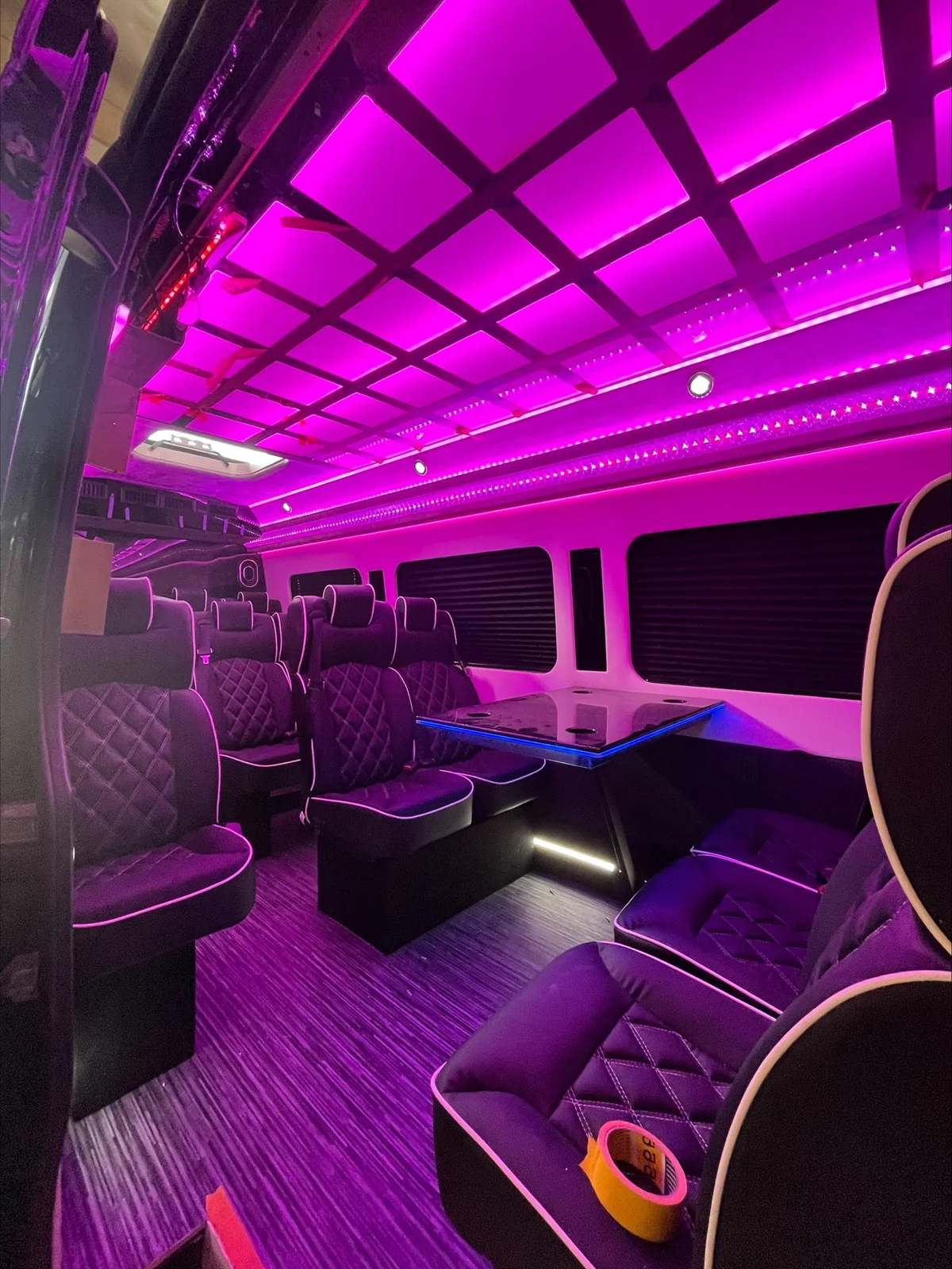 Party bus interior with purple accent lighting